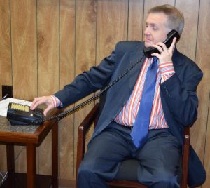 A man uses a touch-tone phone to access the NFB-NEWSLINE system.